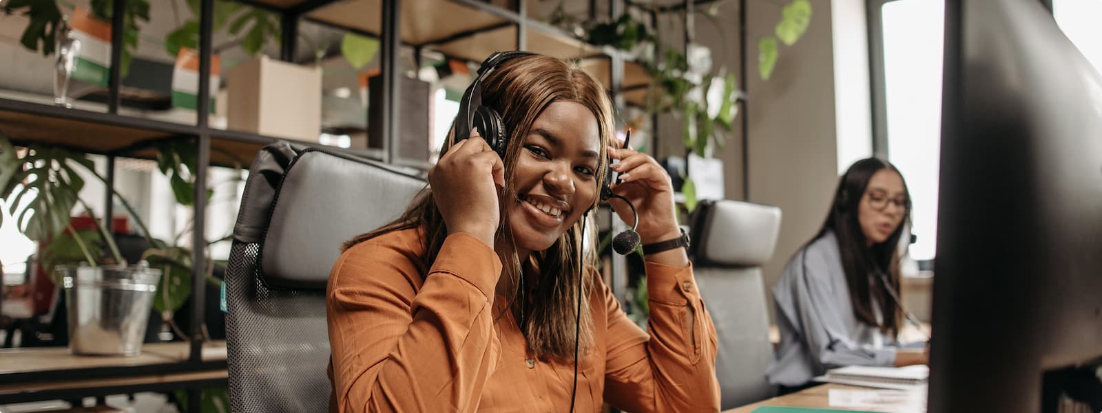 customer service An image of a woman wearing a headset at a call centre